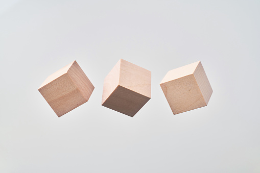 Business & design concept - Abstract geometric real floating wooden cube isolated on background, it's not 3D render.