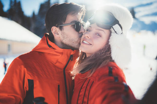 istock Couple on winter holiday taking selfie 1064888236