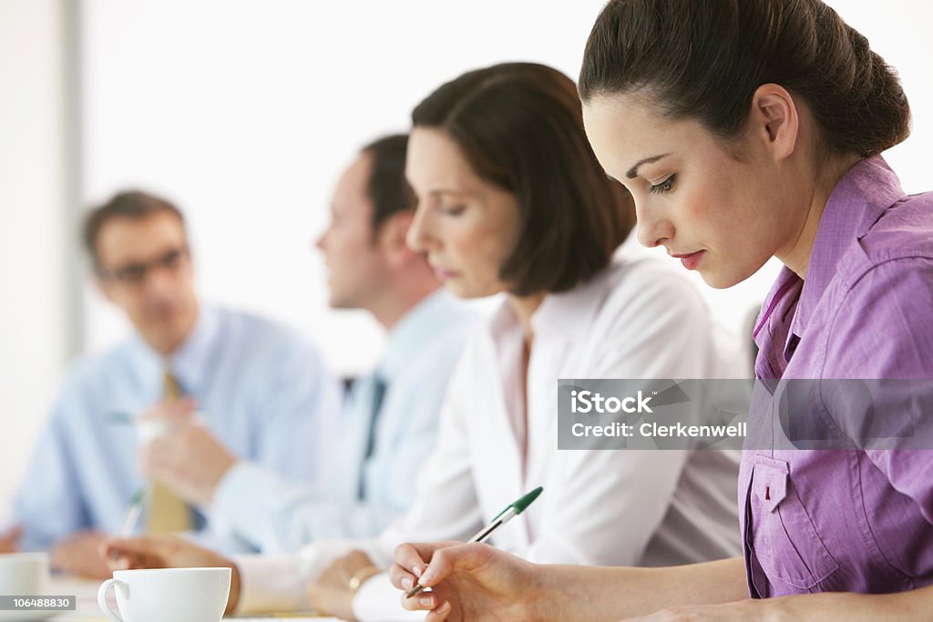 Serious business executives at board room for meeting in office  25-29 Years Stock Photo