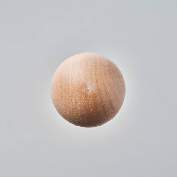 istock Abstract floating wooden half ball on white background 1064888798