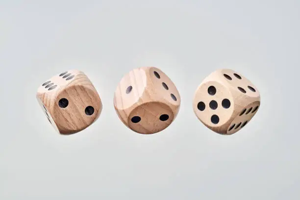 Photo of Abstract floating wooden dice on white background