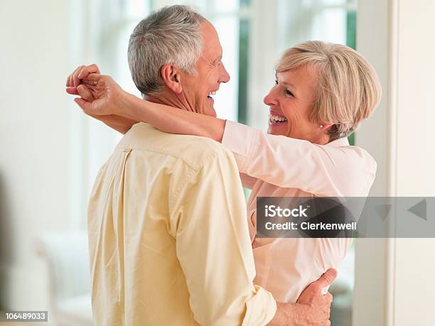 Couple Hugging Each Other Smiling Stock Photo - Download Image Now - 55-59 Years, 60-64 Years, Active Seniors