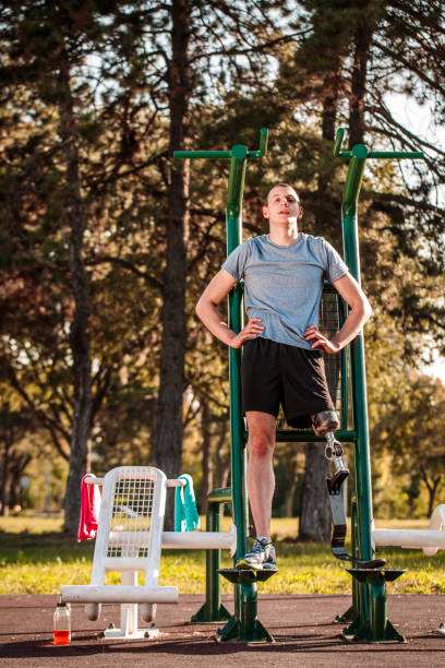 istock Disabled man exercising in outdoor gym 1064890370