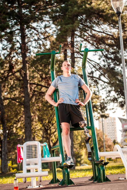istock Disabled man exercising in outdoor gym 1064890380
