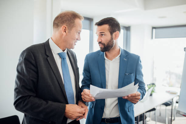 istock Coworkers doing paperwork together 1064893058
