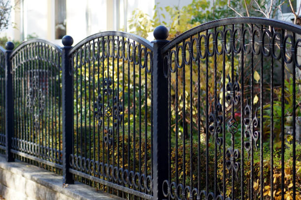 iron garden fence for protection and safety - fence imagens e fotografias de stock