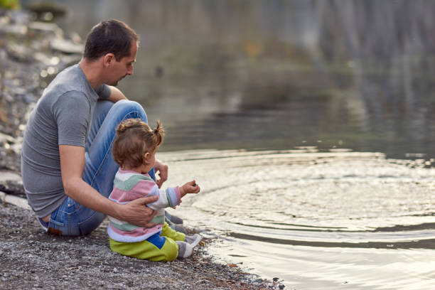 istock father with his baby near lake 1064894830