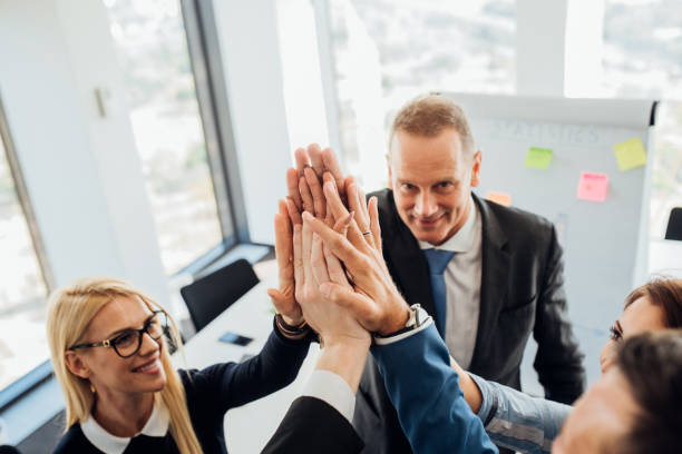 istock Coworkers with their hands raised 1064895564