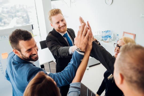 istock Business people stacking their palms 1064895642