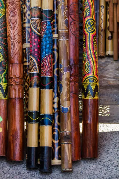 Close up view of a pile of didgeridoo musical instruments.
