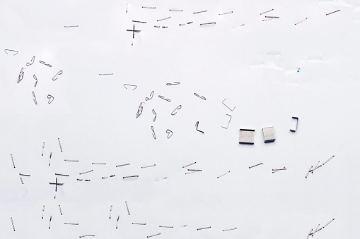 White piece of paper with staple needles.