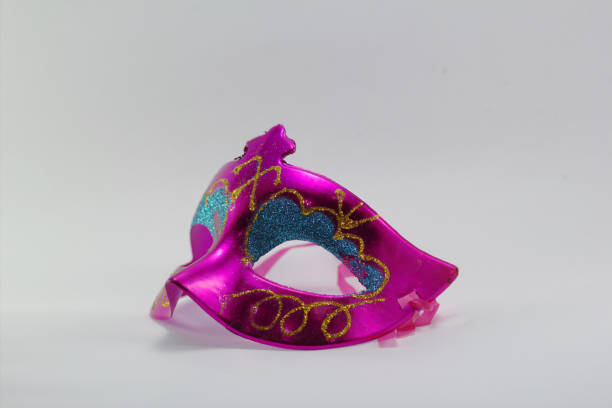 istock Pink fancy mask placed on a white background. 1064896060