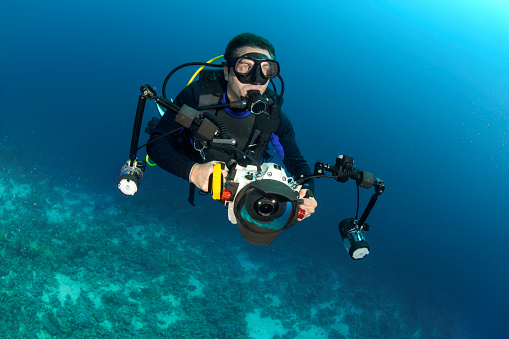 Scuba diver with a camera with underwater housing ready to take some pictures.