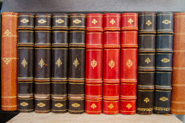 Close up view of antique books on a bookshelf.