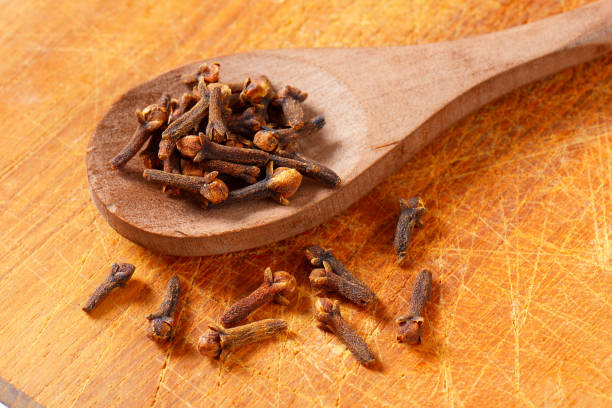 istock Dried cloves on wooden spoon 1064898228