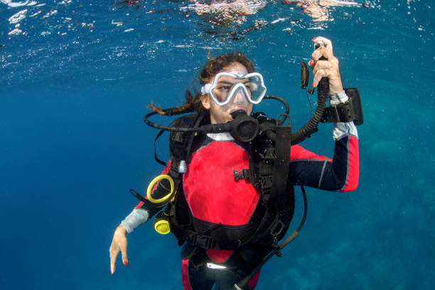 istock Scuba diver girl ascending 1064898990
