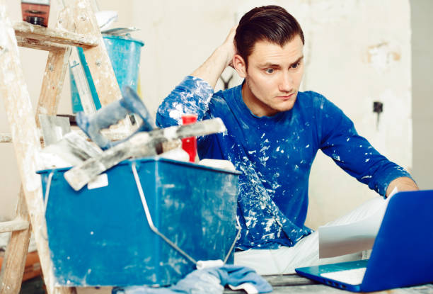 istock Male contractor working with papers and laptop 1064900976