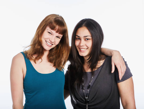 istock Two pretty girlfriends with their arms round each other 1064901658