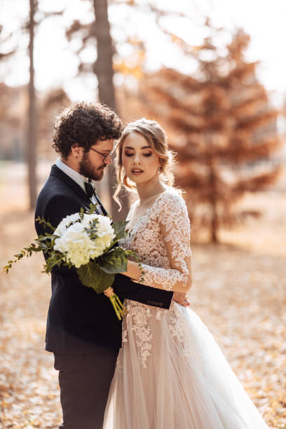 istock Bride and groom embracing in the park 1064904002