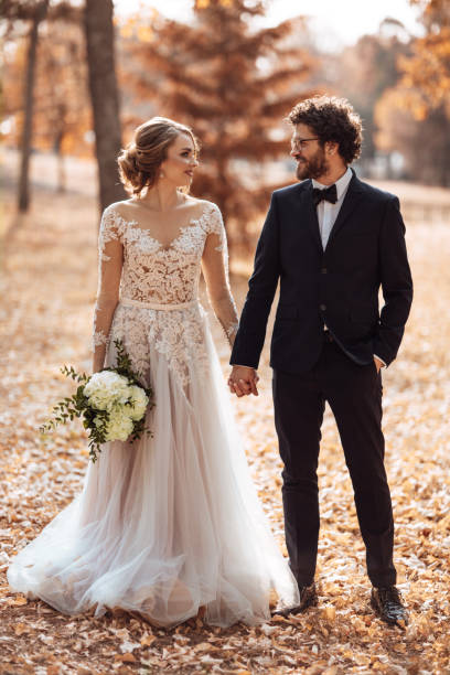 istock Young playful wedding couple holding hands 1064904326