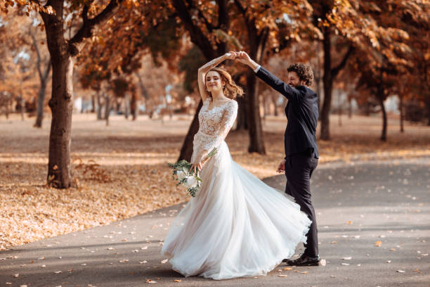 Beautiful wedding couple in park dancing