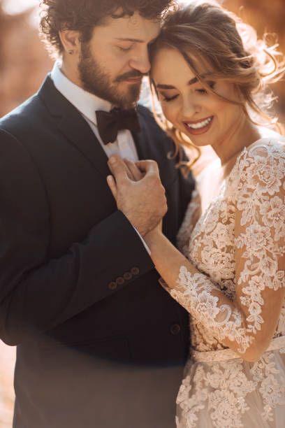 istock Bride and groom embracing in the park 1064906306