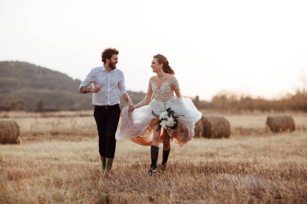 istock Happy married couple running in the fields 1064908790