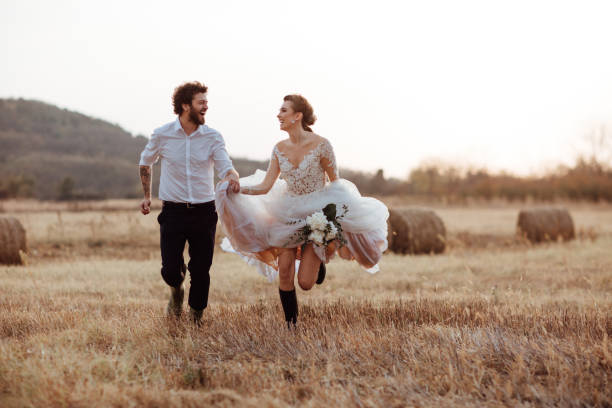 istock Happy married couple running in the fields 1064908968