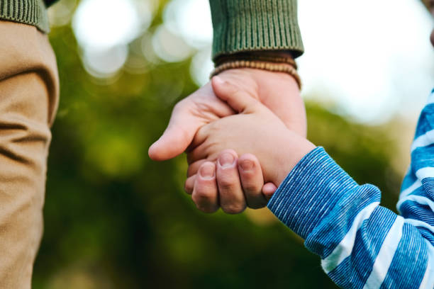 They need guidance Cropped shot of a little boy holding on to his father's hand kids holding hands stock pictures, royalty-free photos & images