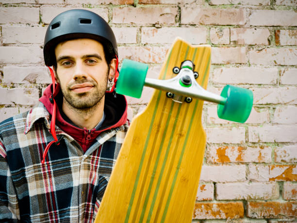Portrait of young man with longboard