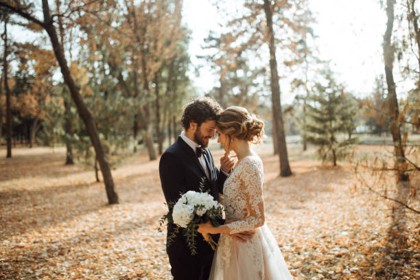 beautiful wedding couple in park. - wedding dress bouquet wedding bride imagens e fotografias de stock