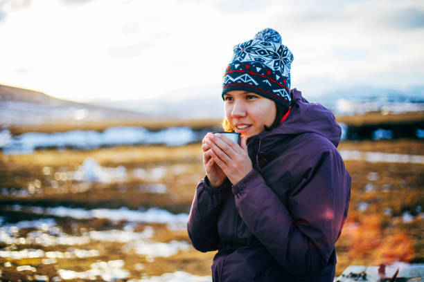 Woman drinks hot tea or coffee