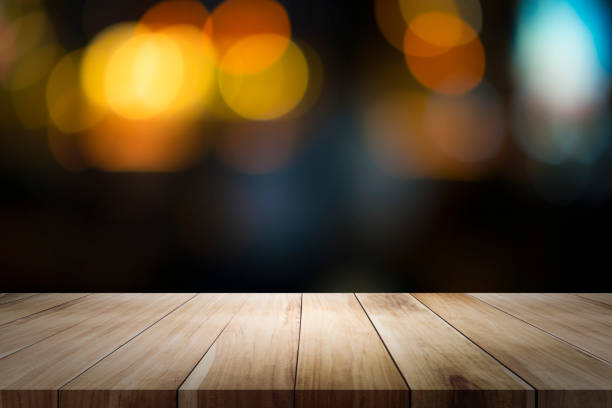 istock Empty wooden table platform and bokeh at night 1064912506