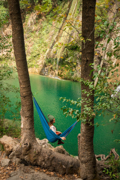 istock Young woman laying in hammock 1064912528
