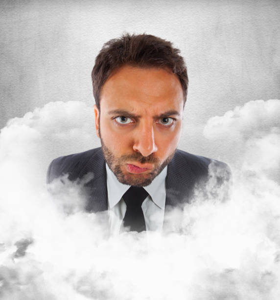 istock Young businessman in the clouds with expression of indecision 1064920394