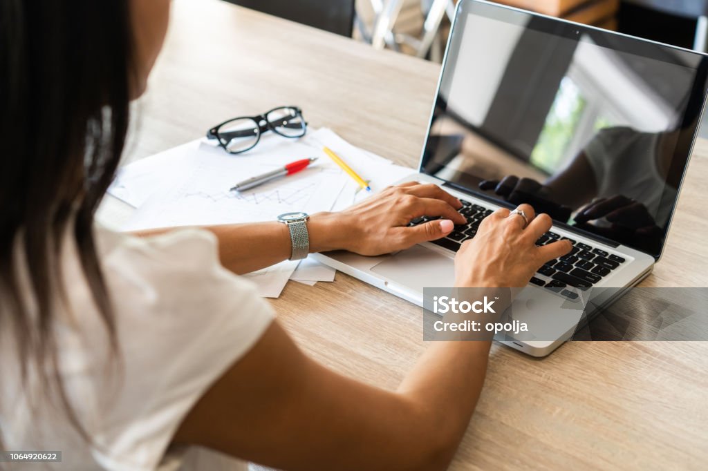 Businesswoman typing on laptop at workplace Woman working in home office hand keyboard Businesswoman typing on laptop at workplace. Woman working in home office hand keyboard Internet Stock Photo