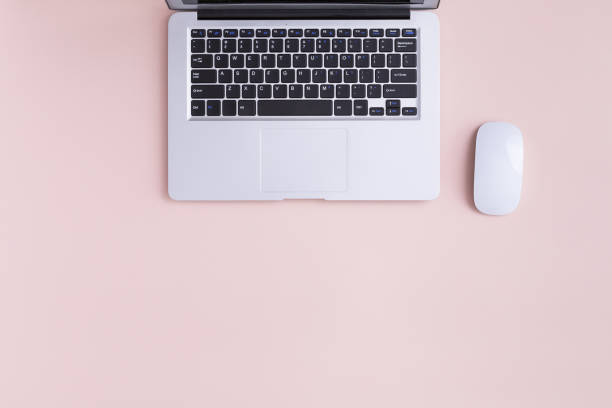 Top view of modern laptop isolated on pink background.
