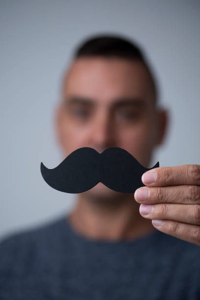 istock young man with a fake moustache 1064923538