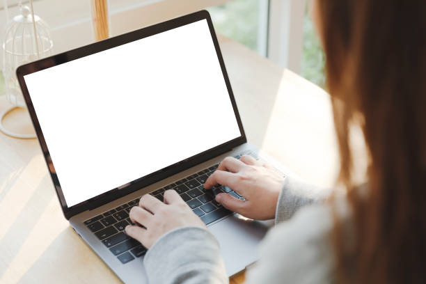 istock Women using laptop with blank screen at table in the office. 1064924234