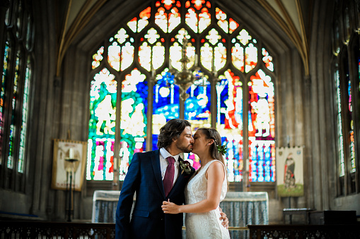 Bride and groom kissing in the church