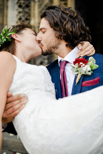 istock Groom lifting up his beautiful bride 1064924478