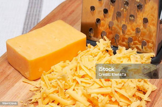 Grated Cheddar Cheese On Wooden Board Stock Photo - Download Image Now - Cheddar Cheese, Cheese, Color Image