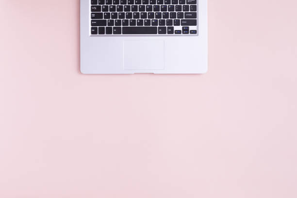 istock Top view of modern laptop isolated on pink background. 1064926764
