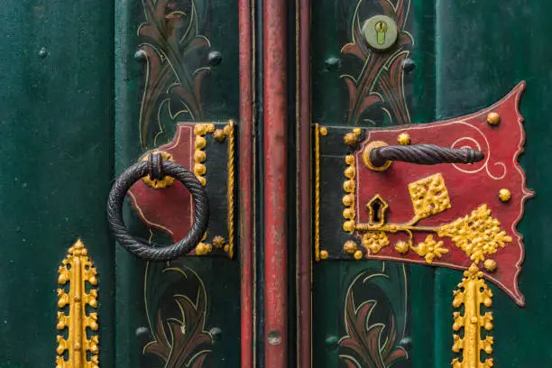 Ornate doorhandle and knocker of St. Georg church in Ulm, Germany.