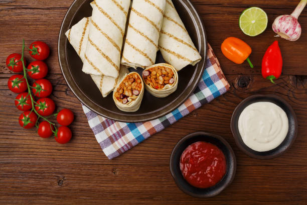 istock Burritos wraps with meat, beans and vegetables. 1064929282