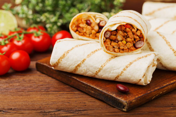 istock Burritos wraps with meat, beans and vegetables. 1064929334