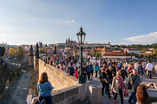 Prague, Czech Republic - September 27, 2014: High angle view of a crowd of people walking on the famous Charles bridge with Prague Castle in the background.  Prague Czech Republic September 27, 2014.