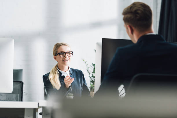 istock selective focus of young business people talking in office 1064930708