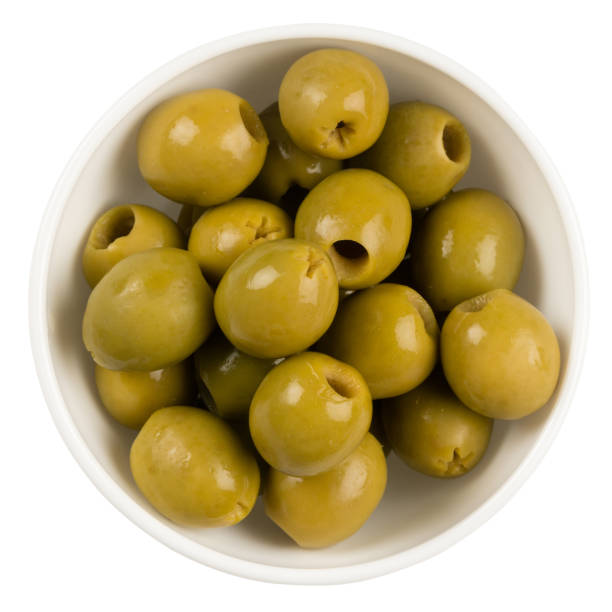 istock Olives in a white plate isolated on white background. Top view. 1064931788