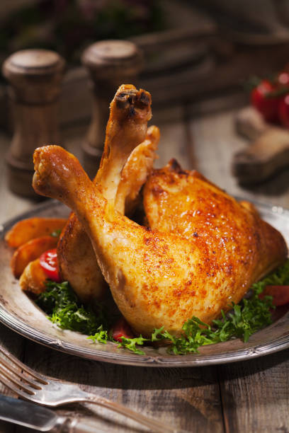 istock Baked chicken leg, served with roasted potatoes and vegetables. 1064933180